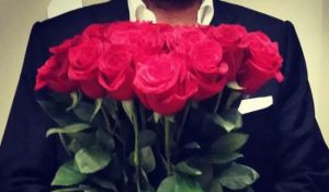 A bunch of Red roses held by a man
